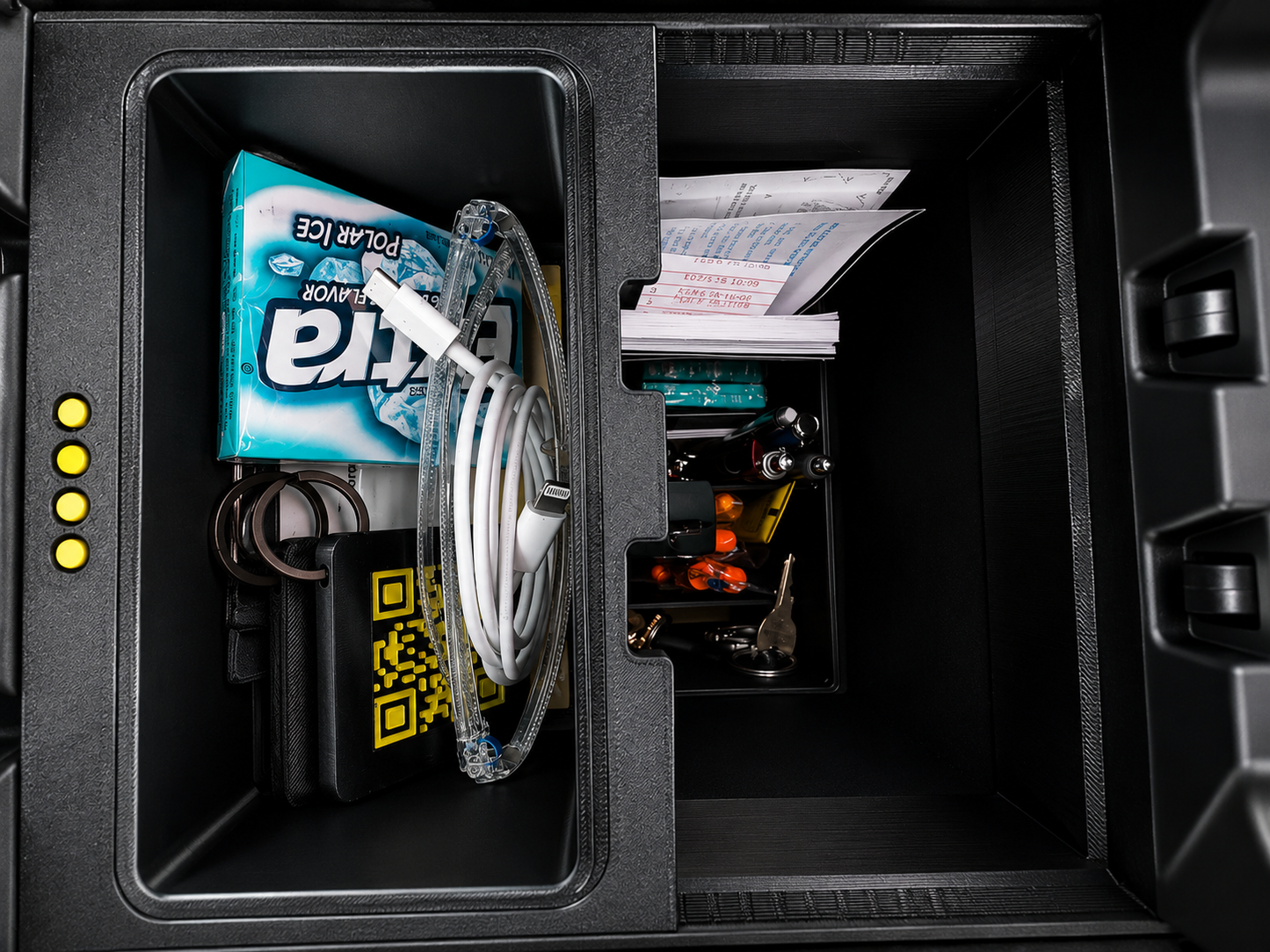 Center console organizer for Rivian R1S / R1T — sliding tray loaded with everyday items, forward position