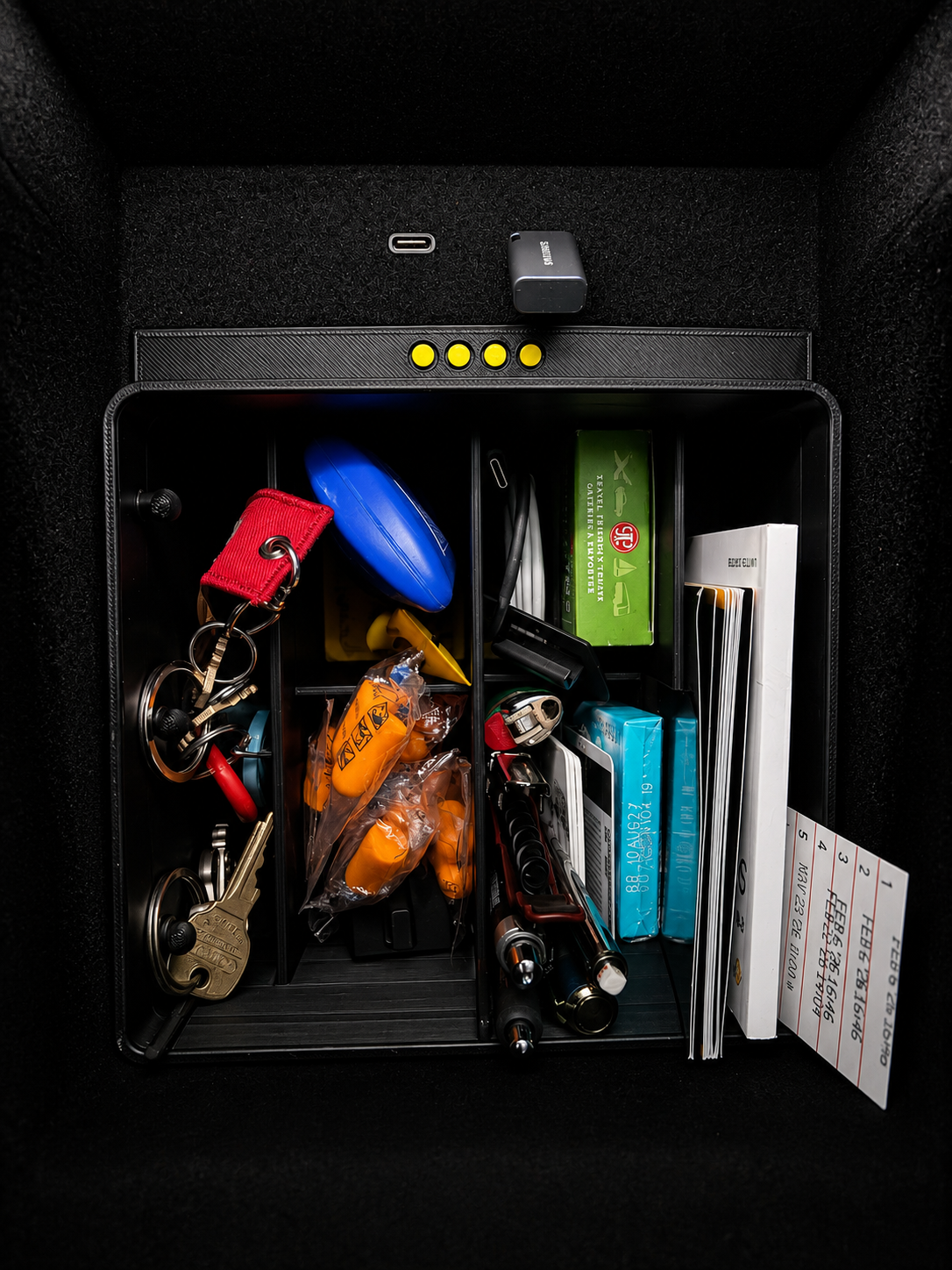 Rivian R1S / R1T console lower bin loaded with everyday items
